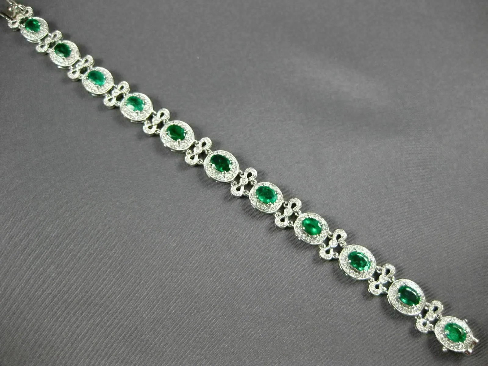 ESTATE WIDE 7.35CT DIAMOND & AAA EMERALD 18KT WHITE GOLD FLOWER TENNIS BRACELET